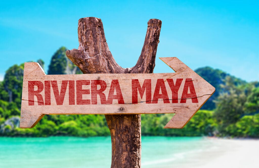 Riviera Maya wooden sign with beach background